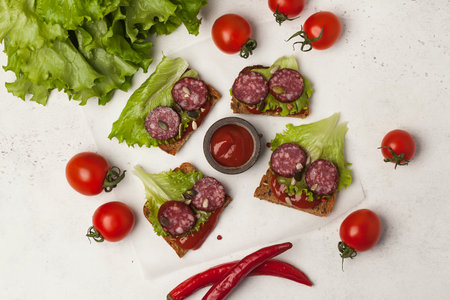 Sandwiches with sausage and herbs. beautiful sliced meat with herbsの写真素材