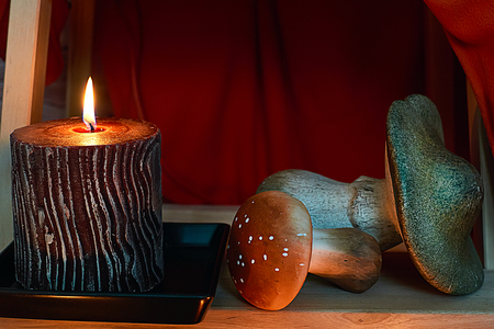 Candle and mushrooms under stairsの写真素材