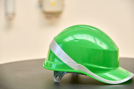 Green safety helmet on a tableの写真素材