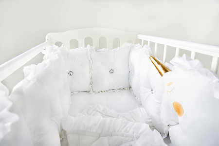 Baby crib with white and soft cushionsの写真素材