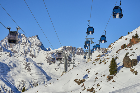 Ischgl, Austria - December 25, 2017: Modern aerial tramway in the Austrian Alps ski resort. Highland cable car leads between hills from village to ski slope.のeditorial素材