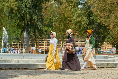 Slavkov u Brna, Czech Republic - August 11, 2018: Slavkov-Austerlitz castle historical reenactment. Ladies and gentlemen in the historical costumes from Napoleon Bonaparte epoch have a walk in parkのeditorial素材