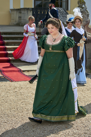 Slavkov u Brna, Czech Republic - August 11, 2018: Slavkov-Austerlitz castle historical reenactment. Ladies and gentlemen in the historical costumes from Napoleon Bonaparte epoch have a walk in parkのeditorial素材
