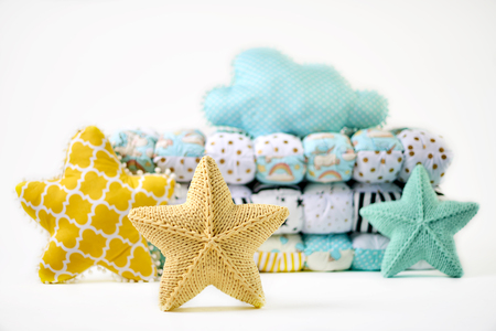 Five-pointed star shaped pillows and patchwork comforter on white backgroundの写真素材