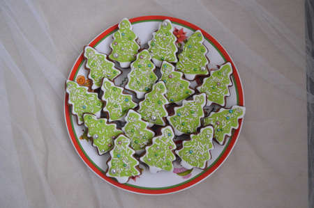 Christmas ginger cookies at green tree and many candy for backgroundの写真素材