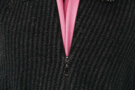 Zipper closure in gray knitted clothingの写真素材
