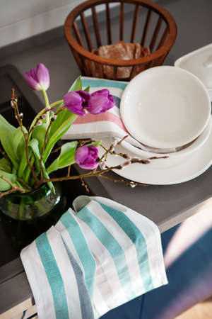 Bouquet of flowers tulips are watered in sink in kitchen