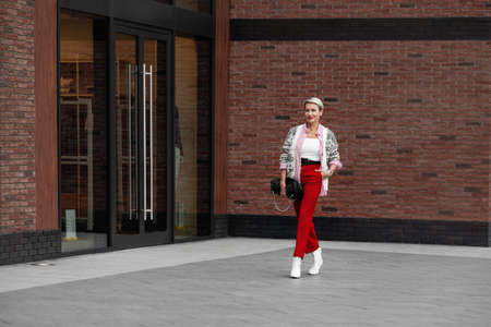 Autumn or Spring street style trend Clothes. Bright casual outfit for business woman walking...