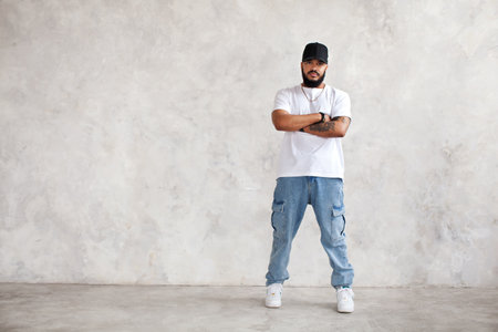 Full length portrait Hispanic man stands arms crossed, in casual wear jeans and white mockup T-shirt...