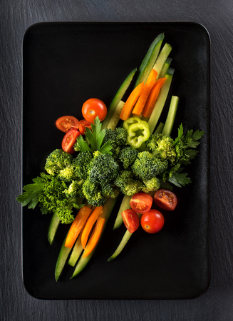fresh vegetable salad on a black plateの写真素材