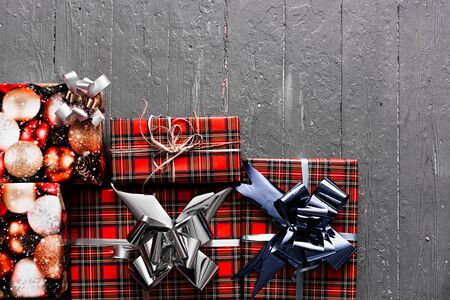 red gift boxes lie on a gray wooden background.の写真素材