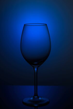 wine glass on a blue background. dishes on the clearance on a blue backgroundの写真素材