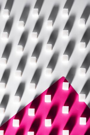on a white and pink background sugar cubes are staggeredの写真素材