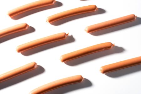 small sausages on a white background in a rowの写真素材
