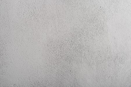 A place for writing text on a background of grained concrete surface, light gray in color.の写真素材