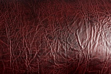 Fragment of a leather sofa. reddish surface of leather furniture.