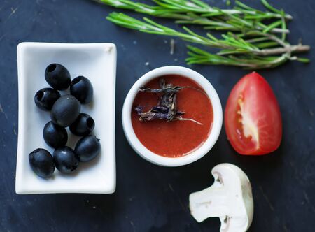 tomato sauce with dry  basil and  black olives.の写真素材