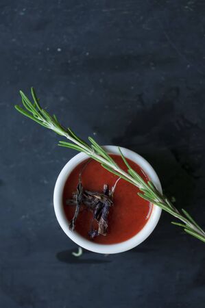 tomato sauce with basil and rosemary on dark background.の写真素材