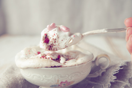 Cup of cappuccino coffe and spoon with whipped cream. Love concept ?の写真素材