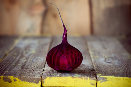 Fresh beetroot sliced in half on wooden boards.の写真素材