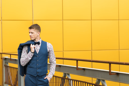 Attractive slender  man in blue suit  posing outdoors.の写真素材