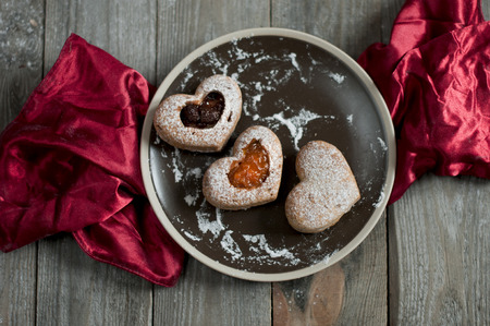 Valentine cupcakes with jam on red tablecloth.の写真素材