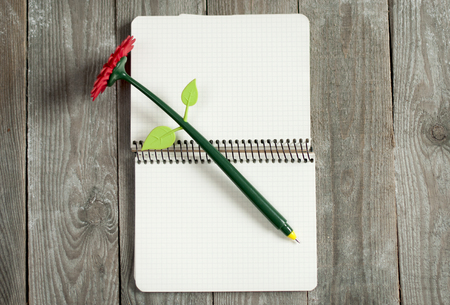 Creative pen flower on   the opened notebook backgroundの写真素材