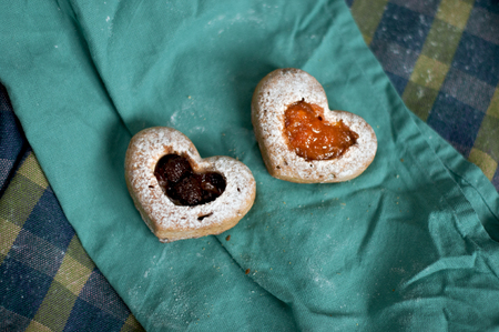 Two love cupcake with jam on tablecloth.の写真素材