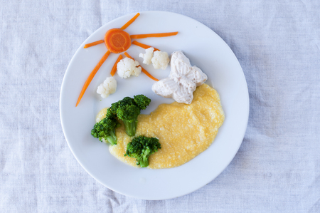 breakfast for child - butterfly  steam cutlet with corn porridge and begetable.の写真素材