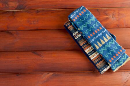 two scarves with patterned coloring on wooden boardsの写真素材