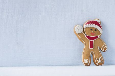 Christmas gingerbread man in front of a blue wallの写真素材