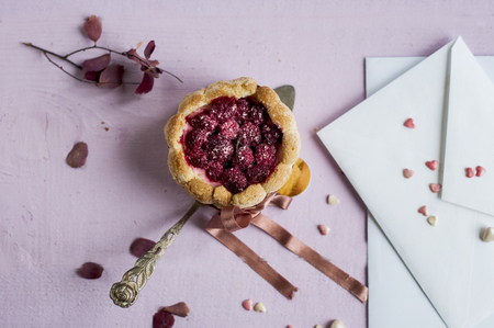 Flat lay french charlotte with raspberry on spoon and white envelop. Greeting cardの写真素材