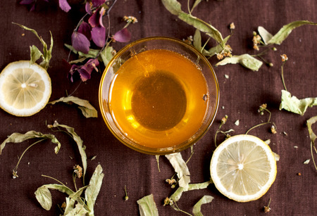 honey in a glass bowl with a linden and lemon for the treatment of virusesの写真素材