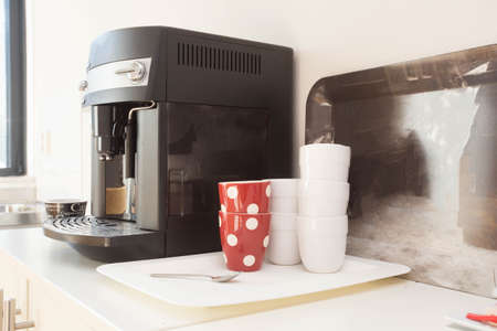 coffee machine preparing fresh coffee and pouring into red cups at restaurant, bar or pub.の写真素材