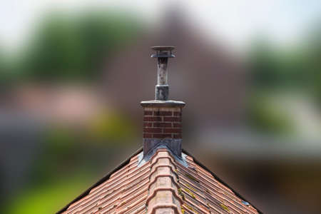 Roof made of ceramic tiles and a brick chimney. old design