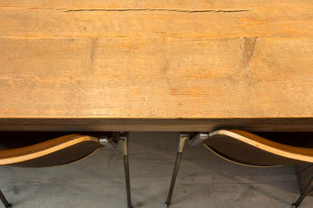 Wooden table with modern chairs top view. interior design background texture