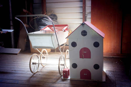 collection of old wood children toys at a dusty old attic in a old house