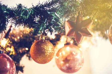 Gold Christmas balls decoration in tree, beautiful sparkles close-upの写真素材
