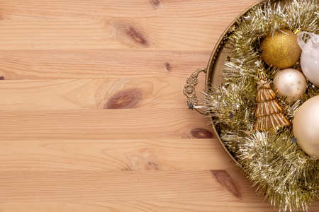 Christmas wooden background with snow fir tree, gold christmas balls View with copy spaceの写真素材