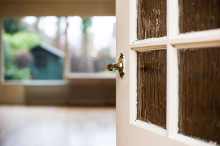 Door knob close-up to the livingroom, home conceptの写真素材