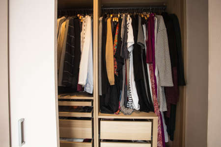 Wardrobe with messy clothes, closeup, fashion design
