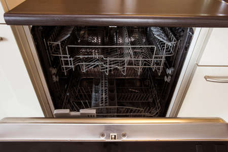 modern Half open empty dishwasher in a modern kitchen close-upの写真素材