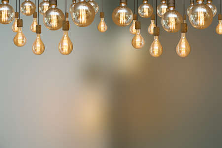 burning retro light bulb on blurred background colorful vintage design