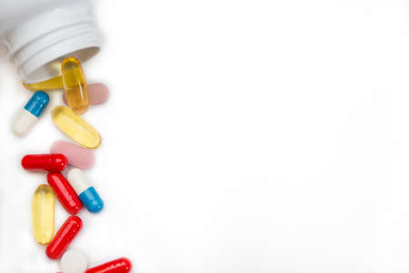 Assorted pharmaceutical medicine pills, tablets and capsules and bottle on white background. Copy space for textの写真素材
