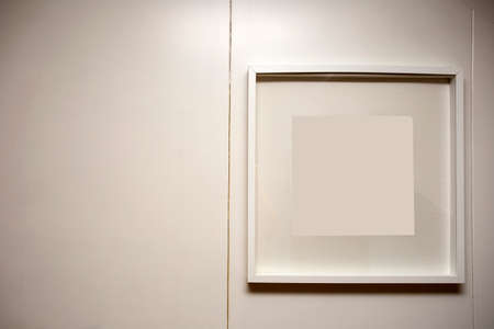 blank frame on a white wall, space for text background texture