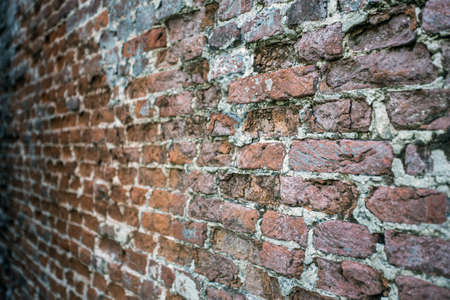 Weathered stained old brick wall background texture, selective focusの写真素材