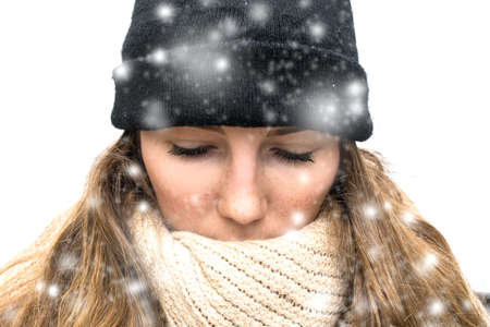 Woman in the Snow with winter wearing, wrapped in winter cap and scarf looking cold isolated on...