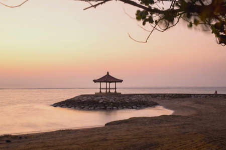 Landscape in Bali colorful sunrise at the beach Sanur, with rest hut and pink orange sky, Indonesia beauty colorfulの写真素材