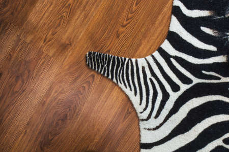 Zebraprint Rug on hardwood oak parquet floor background texture stripesの写真素材