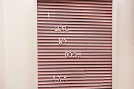 Sign on a wall in a room with the words I love my room, modern decoration